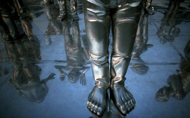 Beijing, China: A detail of one of Chinese sculptor Yue Minjun's gesturing steel figures outside a contemporary art gallery