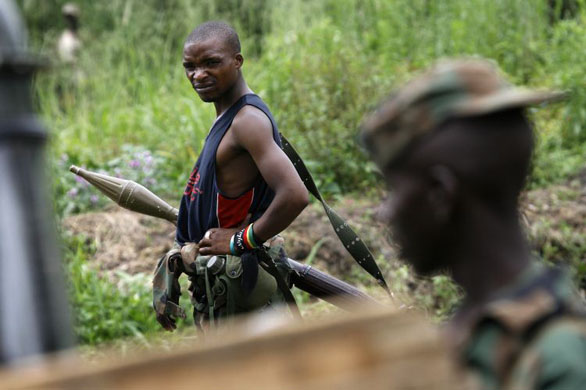 Rebel soldiers loyal to Laurent Nkunda run towards Mai Mai militia, near the village Kiwanja