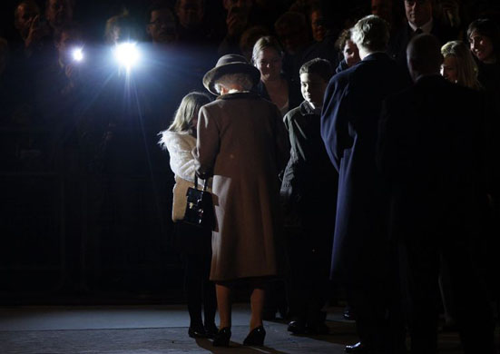 Queen Elizabeth II greets children while attending the Vigil 1914-1918  ceremony at Canada House to mark the 90th anniversary of the end of the World War I    