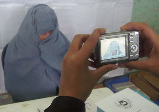 Herat, Afghanistan: A woman registers for presidential elections 