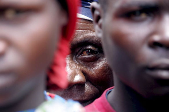 Goma, Congo: Refugees wait outside a rope barrier for their names to be called to receive emergency food rations   