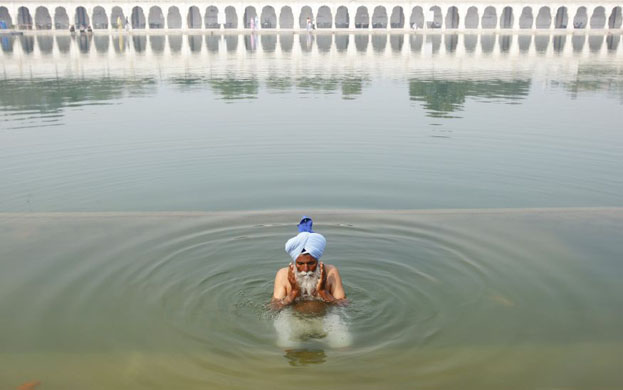 New Delhi, India: A Sikh devotee offers prayers at a gurudwara
