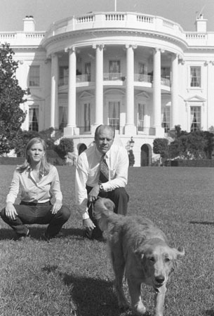 1974: President Gerald Ford and his daughter Susan sit on the White House lawn watching Liberty, a golden retriever, given to the president by his daughter