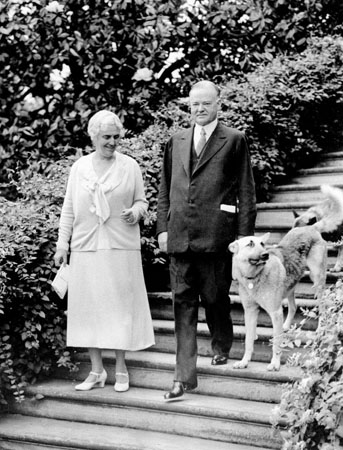 1932: President Herbert Hoover with first lady Lou Henry and their dogs in Washington