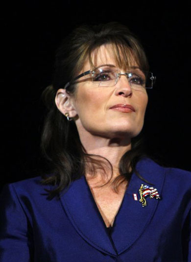 A misty-eyed Sarah Palin listens to McCain speak during his election night rally 