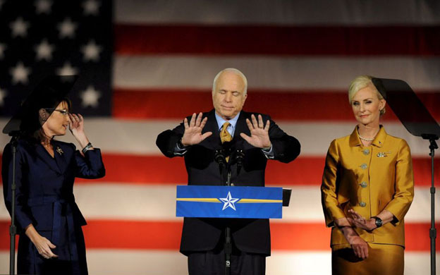 John McCain tries to quieten his supporters while giving his concession speech 