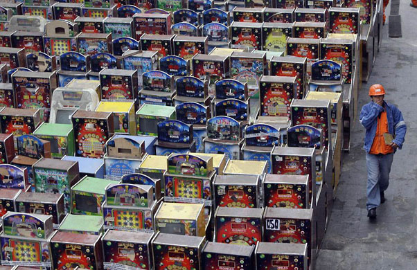 Callao, Peru: A worker walks next to hundreds of illegal gambling machines confiscated by the police