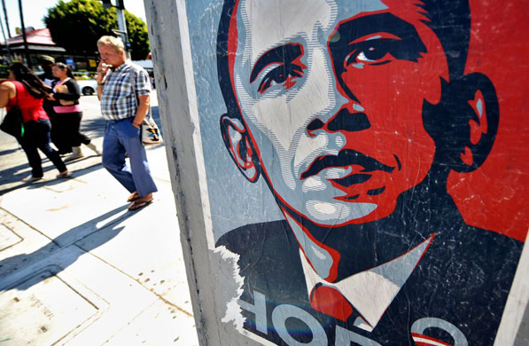 Los Angeles: People walk past a campaign poster for Barack Obama