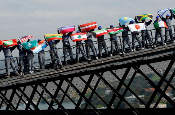 Sydney, Australia: Climbers hold national flags during BridgeClimb's 10th anniversary celebrations on the Sydney Harbour Bridge