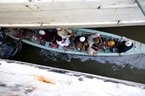 Jakarta, Indonesia: A traditional boat transports some muslim residents for Ied prayer at Sunda Kelapa seaport