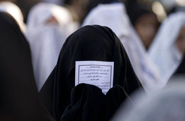 Isfahan, Tehran: A woman prays during the festival of Eid-al-Fitr