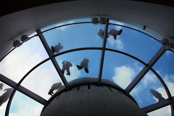 Liverpool, UK: Shoppers walk across the glass floor of a car park stairwell at the new Liverpool One shopping centre on its first full day of trading