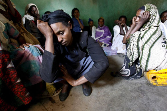 Kararo, Ethiopia: Genet Churo Aliyi mourns the loss of her son Shibre Aliyi at her home with relatives, friends and neighbours
