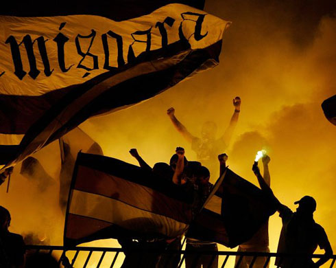 Belgrade, Serbia: Supporters of  FC Timisoara light flares during their team's soccer match against Partizan in the UEFA Cup first round, second leg