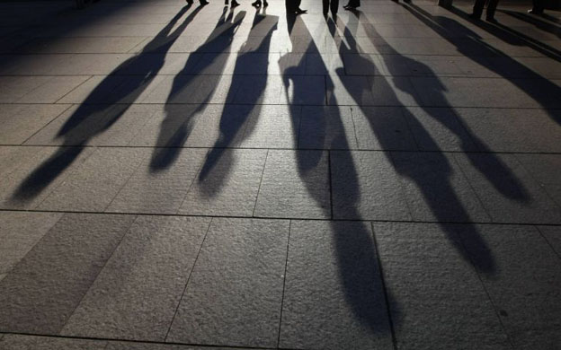 Sydney, Australia: Shadows of office workers as they line up at a traffic light