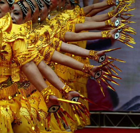 Chengdu, China: Senior citizens give a performance of the 'Thousand-hand Goddess of Mercy' to celebrate this year's Chongyang Festival