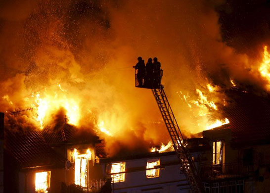 Santander, Spain: Firefighters work on a large fire caused by a gas explosion