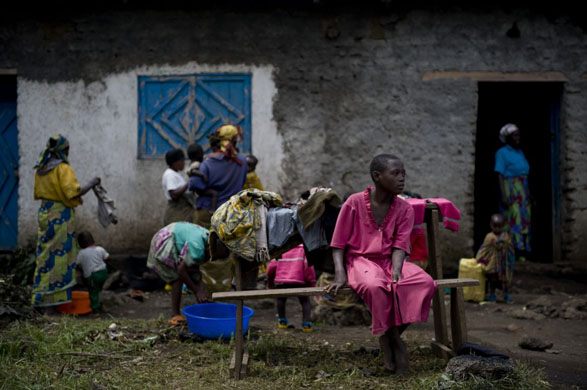 Kibumba, Democratic Republic of Congo: A group of people stand outside a school near the Kibumba internally displaced people's (IDP) camp