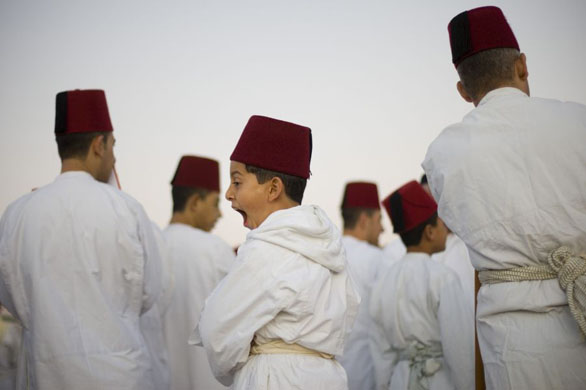 Mount Gerizim, West Bank: A young boy of the ancient Samaritan community yawns during the pilgrimage for the holiday of Tabernacles