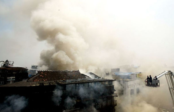 Kalbadevi, India: Firefighters battle to put out a fire in a building