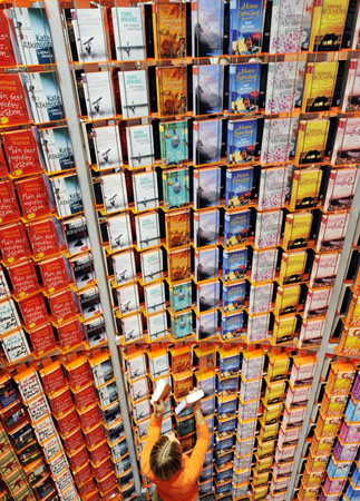 Frankfurt, Germany: A worker arranges books in shelves at an editor's stand at the 60th Frankfurt Book Fair