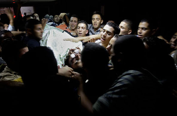 Ramallah, West Bank: Mourners carry the body of Abdelkhader Badawi who was shot and killed by Israeli troops near the West Bank Jewish settlement of Bet El