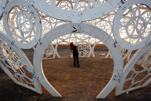 Tweefontein, South Africa: A party goer looks up at the huge wooden art instillation at the heart of the Afrika Burns festival