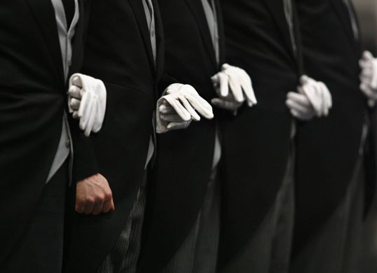 Munich, Germany: Butlers stand in a row during the Millionaire Fair