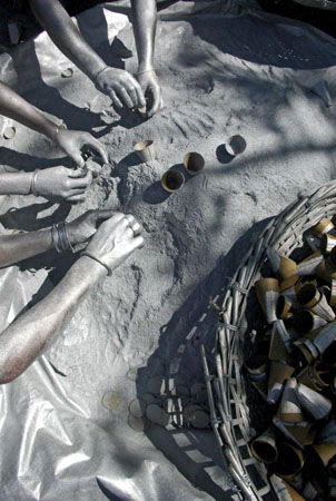 Siliguri, India: Workers use their bare hands to fill gunpowder as they make firecrackers ahead of the Hindu festival Diwali