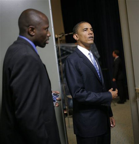 Obama, enters an interview room with Reggie in San Diego