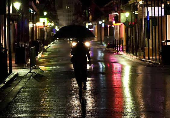 New Orleans, US: As the rain begins, a woman carrying an umbrella walks down Bourbon Street after a mandatory evacuation was ordered ahead of hurricane Gustav