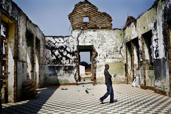 Humbo, Angola: A man walks trough a destroyed building