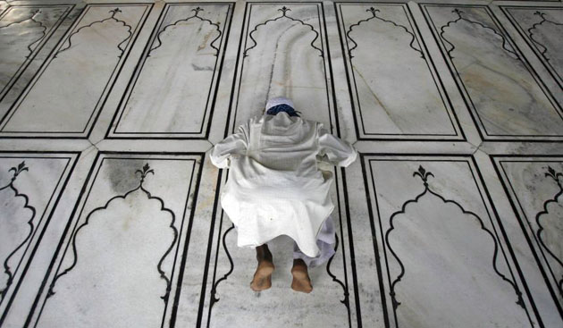 Delhi, India: A Muslim offers evening prayer on the first day of Ramadan at the Jama Masjid (grand mosque)