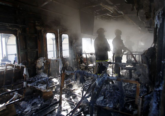 Buenos Aires, Argentina: Firefighters put out a blaze in a carriage on a train
