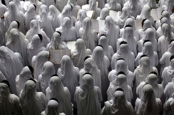 Kolkata, India: Catholic nuns from the Missionaries of Charity order sing hymns for a special prayer during the eleventh anniversary of the death of Mother Teresa