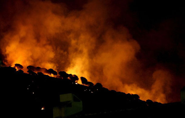 Malaga, Spain: A forest fire rages through the area