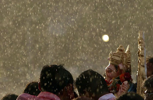 Mumbai, India: Devotees carry an idol of the Hindu god Ganesha for immersion into the sea