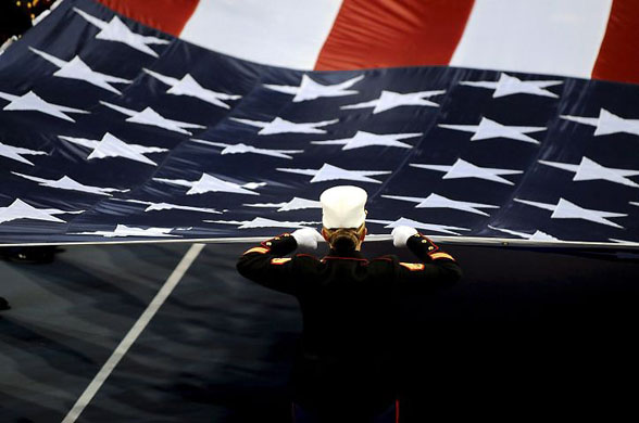 New York, US: Marines unfurl a US flag across centre court prior to the start of the women's final between Serena Williams and Jelena Jankovic