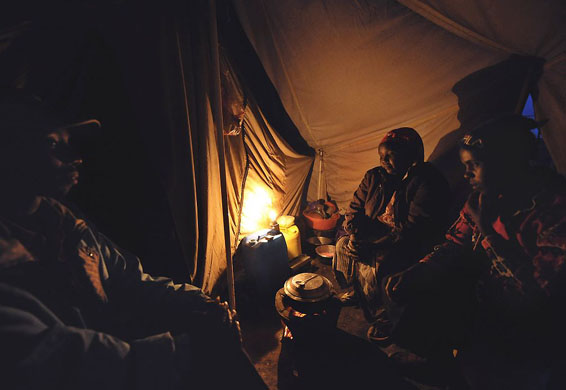 Naivasha, Kenya: A displaced family sits inside a tent at a camp