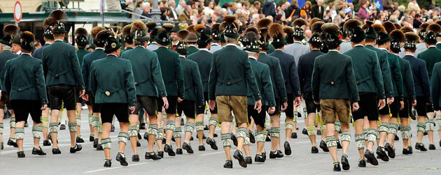 Munich, Germany: Men wearing traditional Bavarian clothes take part in a parade