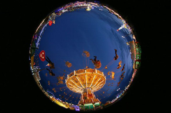 Munich, Germany: Visitors ride a merry-go-round at the second day of the Oktoberfest
