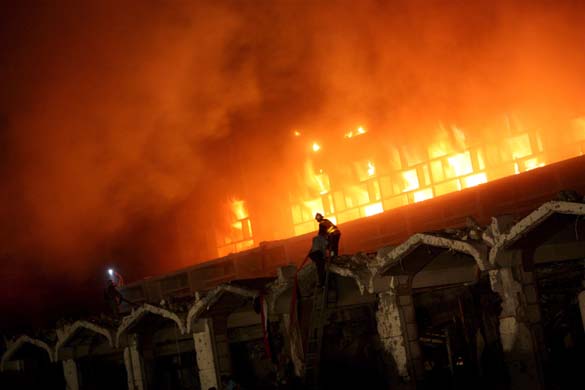 Firefighters work to extinguish the flames at the Marriott hotel