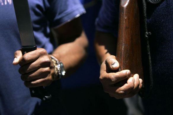 Armed supporters of President Evo Morales march through the streets of La Paz