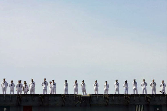 Yokosuka, Japan: Crew members stand on deck on board the nuclear-powered US aircraft carrier USS George Washington at Yokosuka Naval Base