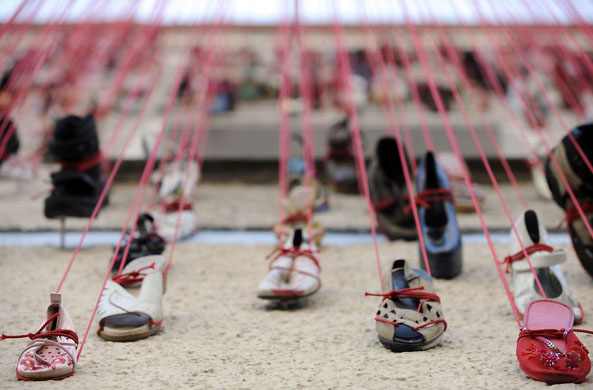Berlin, Germany: A sculpture by Chiharu Shiota involving hundreds of shoes stuck to the facade of a building