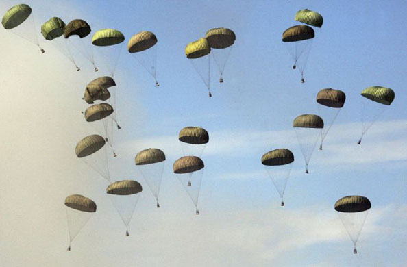 Pocheon, South Korea: Military supply goods are dropped from a C-130 cargo plane during a live fire demonstration