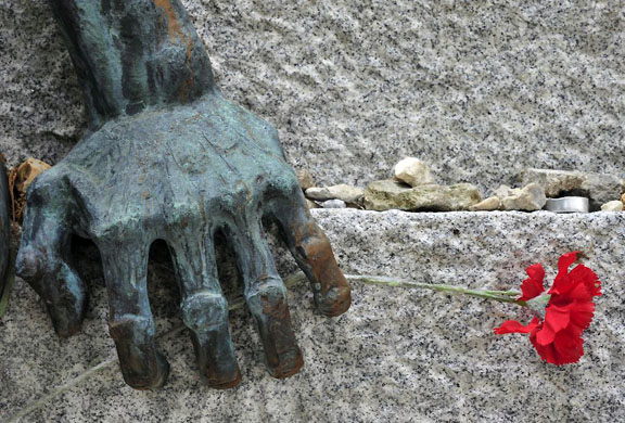 Paris, France: A red carnation hangs from one of the hands of the statue that commemorates the French who died at the Mauthausen WWII concentration camp