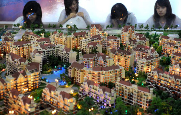 Chengdu, China: Visitors view building models at the 32nd Chengdu Real Estate Trade Fair