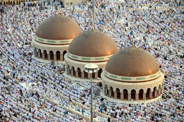 Mecca, Saudi Arabia: Hundreds of thousands of Muslims perform the early morning Eid Al-Fitr prayers at the al-Haram Grand Mosque