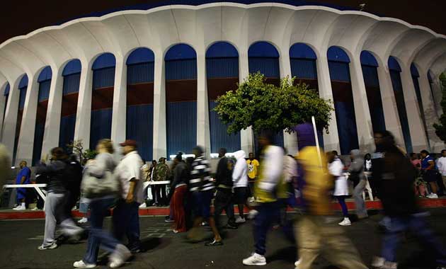 Uninsured people wait outside arena hoping to be treated